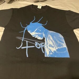 Black Graphic T-Shirt of Travis Scott in blue with a Nike sign and says Utopia.